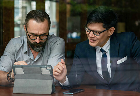 business people looking at a tablet