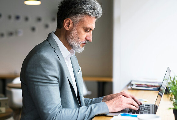 man with a suit on his computer