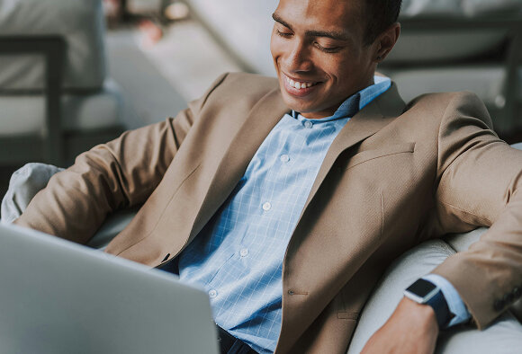 relaxed business man looking at his computer